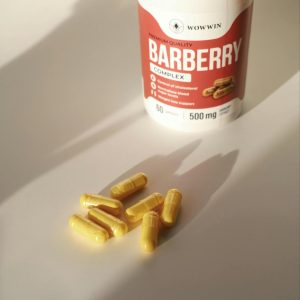 High-quality Barberry Complex supplement bottle alongside capsules in soft lighting.